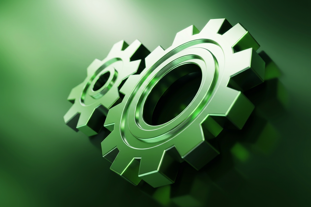 Two green metallic gears interlocking, representing mechanical cooperation and technology in a sleek 3D rendering.