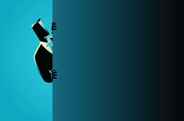 Silhouette of a businessman in a suit peeking around a corner, half hidden against a split blue background